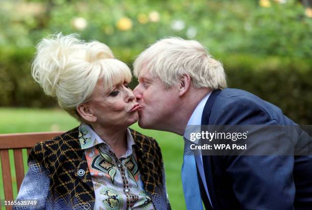 Britain's Prime Minister Boris Johnson kisses television actor Barbara Windsor during a meeting in London on September 2, 2019 in London, England....