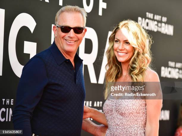 Kevin Costner and Christine Baumgartner attend the premiere of 20th Century Fox's "The Art of Racing in the Rain" at El Capitan Theatre on August 01,...