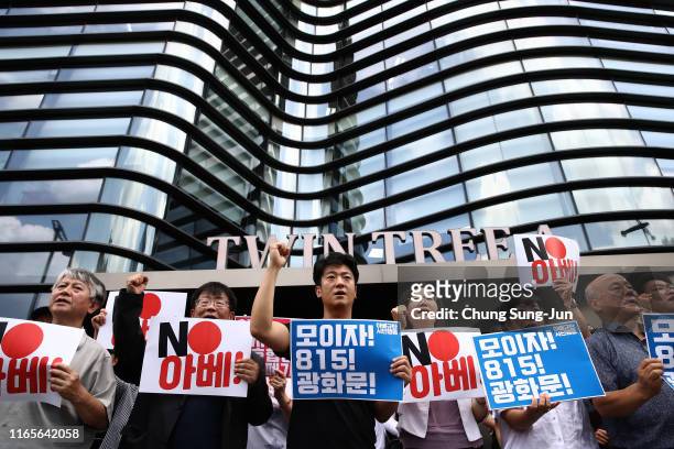 South Korean protesters hold a placard during a protest against Japan's decision to remove South Korea from a "whitelist" of favoured export...