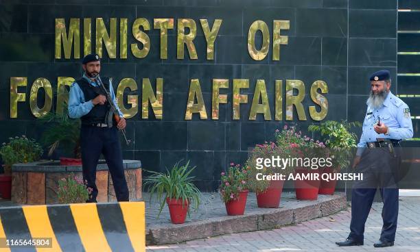 Pakistani policemen stand guard outside the Pakistan's Foreign Ministry building on the arrival of Indian diplomats to meet with an Indian spy...