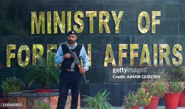 Pakistani policeman stands guard outside the Pakistan's Foreign Ministry building on the arrival of Indian diplomats to meet with an Indian spy...