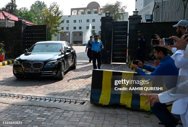 Car carrying Indian diplomats is pictured as they leave the Pakistan's Foreign Ministry building after meeting with an Indian spy Commander...