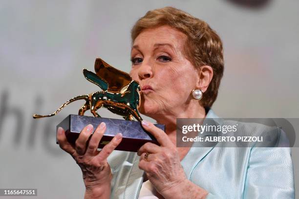 British actress Julie Andrews kisses her award on September 2, 2019 after receiving a Golden Lion for lifetime achievement during a ceremony at the...