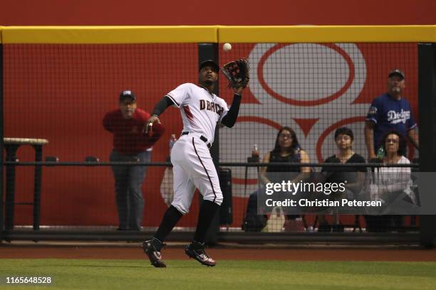 Outfielder Adam Jones of the Arizona Diamondbacks catches a fly ball out against the Los Angeles Dodgers during the MLB game at Chase Field on June...