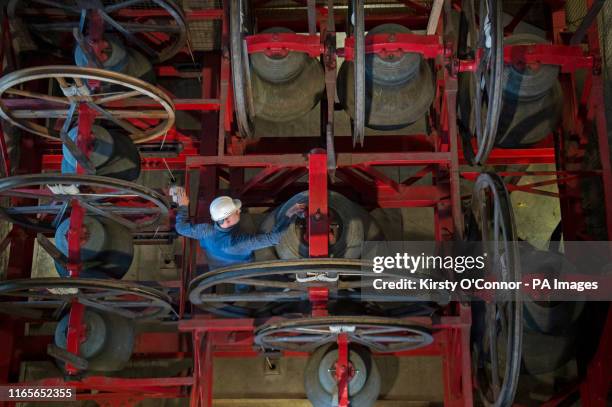 Director of Conservation Housekeeping Christopher Powell cleans a bell in Westminster Abbey's bell tower in London.