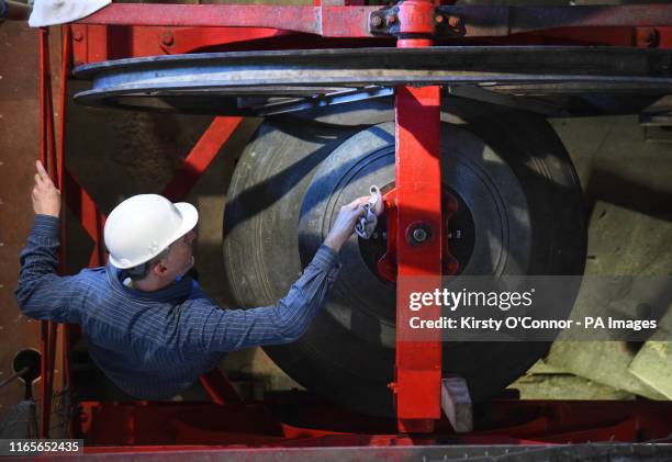 Director of Conservation Housekeeping Christopher Powell cleans a bell in Westminster Abbey's bell tower in London.