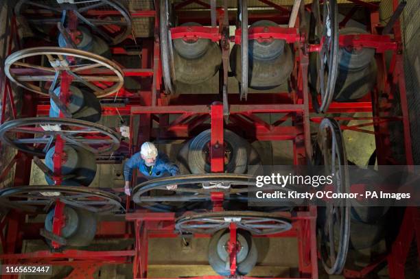 Director of Conservation Housekeeping Christopher Powell cleans a bell in Westminster Abbey's bell tower in London.
