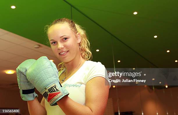 Wimbledon No 1 Seed Caroline Wozniacki of Denmark poses for a photograph in a boxercise class organised by COMPEED® for tennis fans during a COMPEED®...