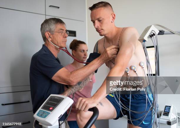 Dr. Klaus Neye examines new arrival Marius Wolf of Hertha BSC during the medical check up on September 2, 2019 in Berlin, Germany.
