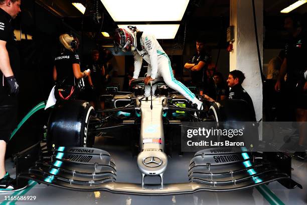 Lewis Hamilton of Great Britain and Mercedes GP prepares to drive in the garage during practice for the F1 Grand Prix of Hungary at Hungaroring on...