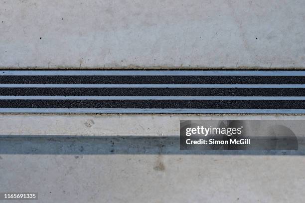 metal and textured abrasive non-slip safety tread on outdoor concrete steps - non urban scene bildbanksfoton och bilder