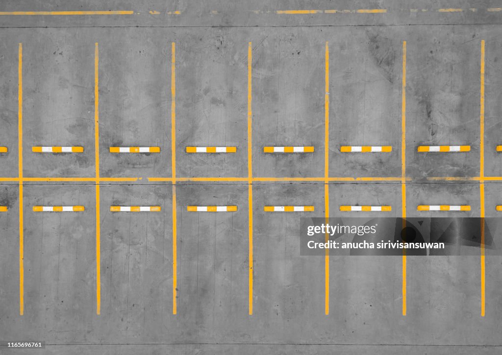 Aerial top view car park road dividing line yellow without cars.