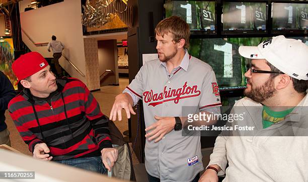 Drew Storen, relief pitcher for the Washington Nationals, is seen talking to Mike O'Hara and Ryan Wagner at the MLB Fan Cave located on Broadway and...