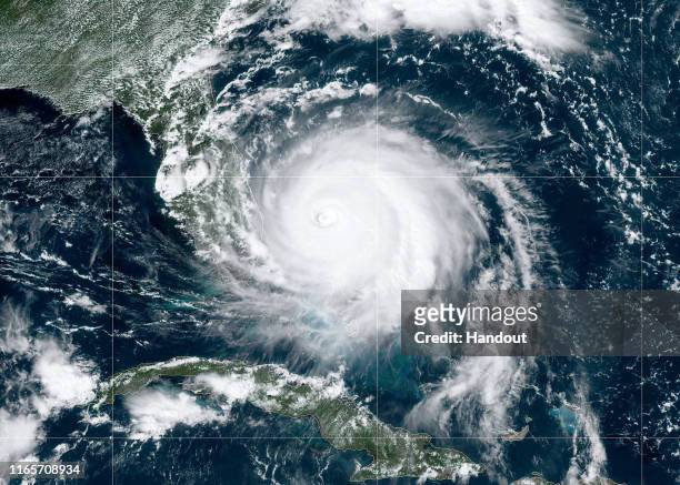 In this NOAA GOES-East satellite handout image, Hurricane Dorian, now a Cat. 4 storm, moves slowly past Grand Bahama Island on September 2, 2019 in...