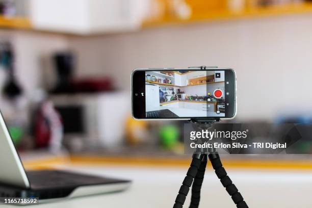 smartphone ready for vlogging in the kitchen - tripod stock-fotos und bilder