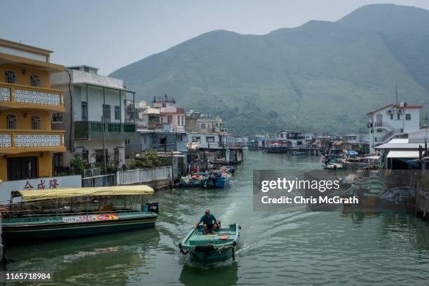 Boat passes stilt houses in the fishing village of Tai O on July 18, 2019 in Hong Kong, China. Hong Kong’s earliest settlements were fishing villages...