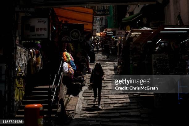 Woman walks down Pottinger street on July 16, 2019 in Hong Kong, China. The famous Pottinger Street was named in 1858 after Henry Pottinger, the...