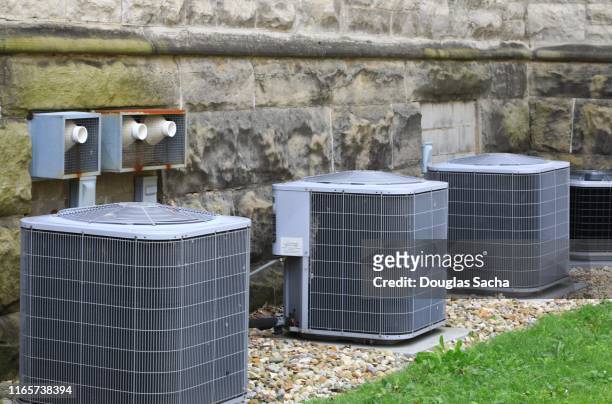 multiple air conditioner units outside of a building - air conditioning stock pictures, royalty-free photos & images