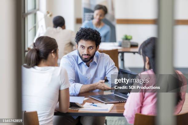 personal banker instructs clients concerning online banking - corporate storytelling stock pictures, royalty-free photos & images