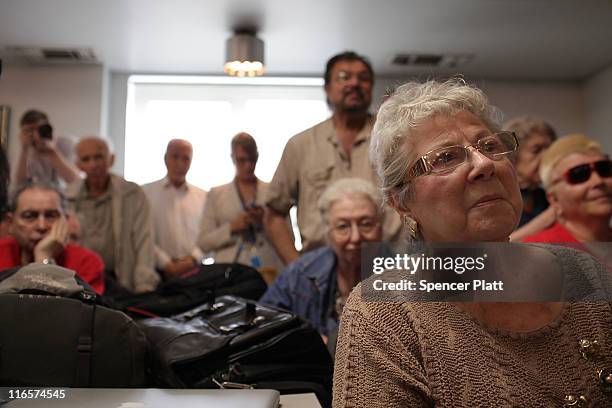 Brooklyn constituents of Rep. Anthony Weiner , including Hilda Baxt watch as he announces his resignation June 16, 2011 in the Brooklyn borough of...