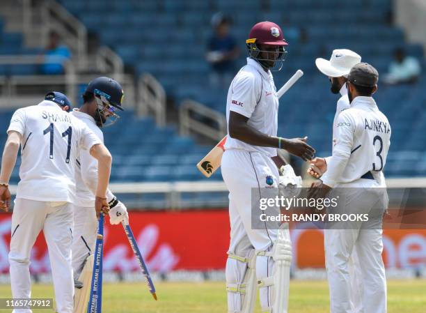 Jason Holder of West Indies congratulate Ajinkya Rahane of India for winning on day 4 of the 2nd Test between West Indies and India at Sabina Park,...