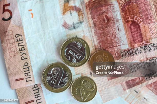 This photo illustration show The Belarusian ruble or rouble , the official currency of Belarus banknotes and coins are seen in Grodno, Belarus on 1...