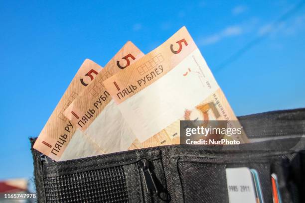 This photo illustration show The Belarusian ruble or rouble , the official currency of Belarus banknotes in a wallet are seen in Grodno, Belarus on 1...