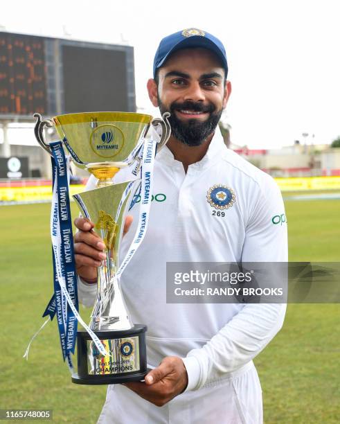Virat Kohli of India poses with the trophy after winning on day 4 of the 2nd and final Test between West Indies and India at Sabina Park, Kingston,...