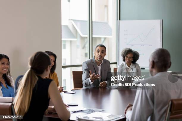 businessman makes a point during meeting - boardmember stock pictures, royalty-free photos & images