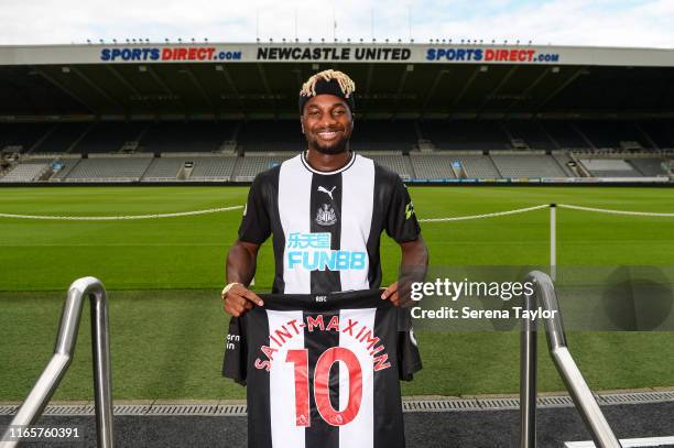 New Newcastle United signing Allan Saint-Maximin poses for photographs pitchside wearing a Home Shirt during a photocall at St.James' Park on August...