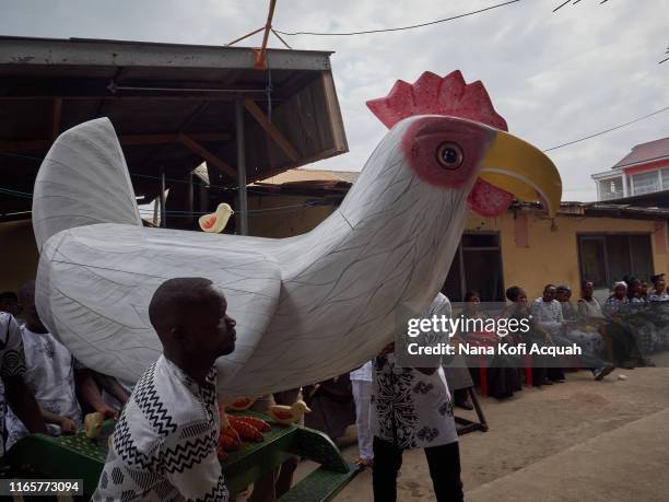 Mourners carry the fantasy coffin of the late Madam Aba Asiedu , who will be buried in a mother hen coffin, a symbol of the many children she raised...