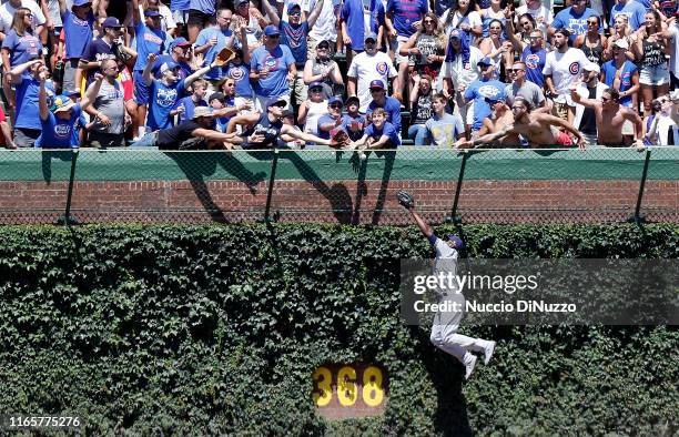 Lorenzo Cain of the Milwaukee Brewers is unable to catch the home run ball hit by Jason Heyward of the Chicago Cubs during the first inning of a game...