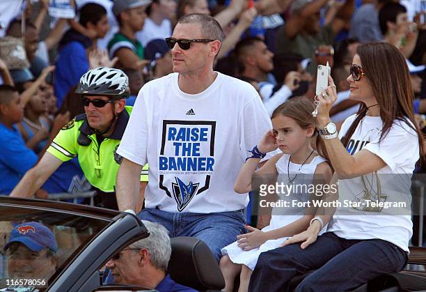 Dallas Mavericks head coach Rick Carlisle with his family rides along Houston Street during the Mavericks victory parade through downtown Dallas,...