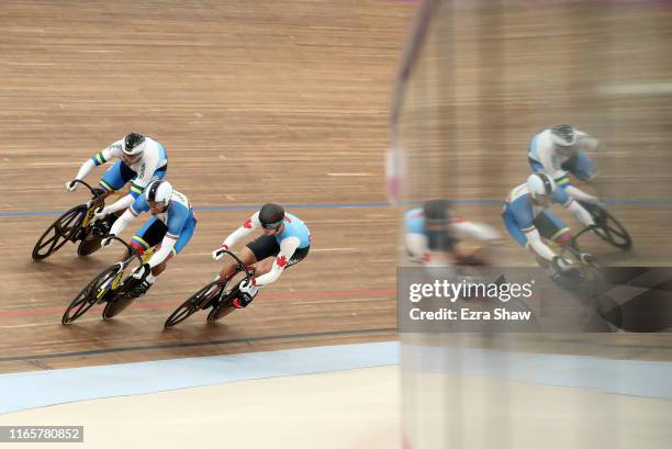 Kacio Fonseca Da Silva of Brazil races against Nick Wammes of Canada and Cesar Mervin Marcano Sanchez of Venezuela during their race in the men's...