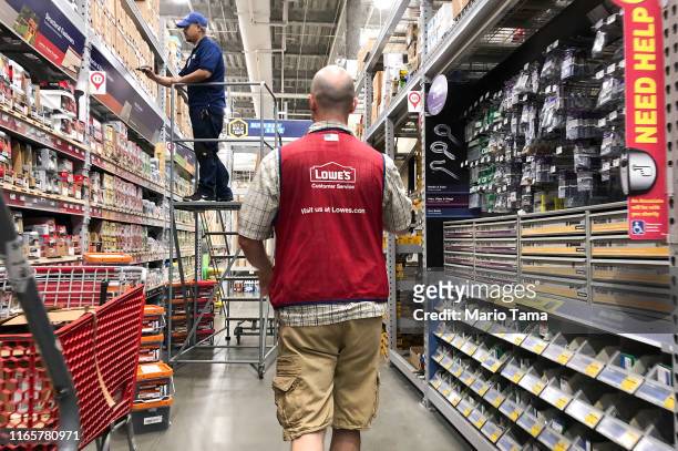 Employees work inside a Lowe's store on August 2, 2019 in Los Angeles, California. The home Improvement retailer is set to lay off thousands of...