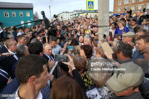Russian President Vladimir Putin talks to local residents crowded by the city adminitraion on September 2, 2019 in Tulun, Irkutsk region, Russia....