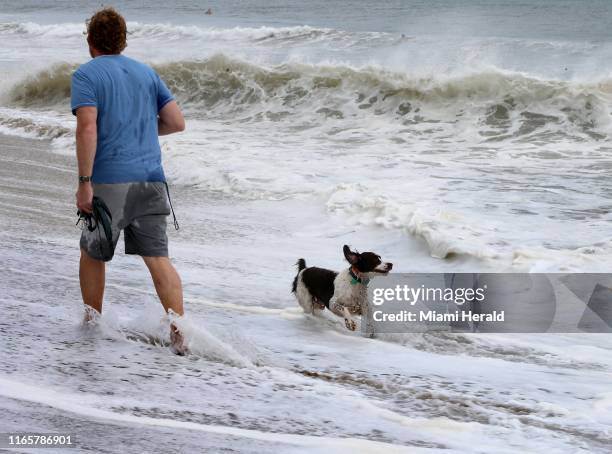 Dog runs along the coast line on Spanish River Park beach in Boca Raton as Hurricane Dorian now a Cat 4, lashing Bahamas as it crawls toward Florida...