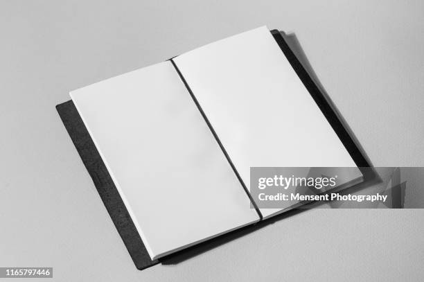 open book with blank pages on gray background - blank magazine ad stockfoto's en -beelden