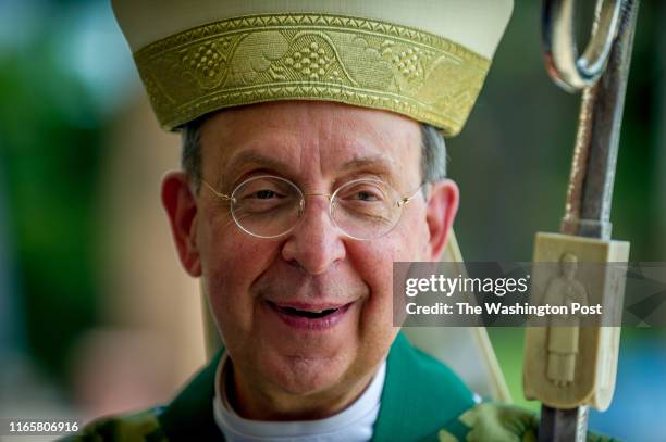 Archbishop William Lori, head of the Archdiocese of Baltimore, greets parishioners after delivering Sunday Mass at Holy Family Catholic Church on...