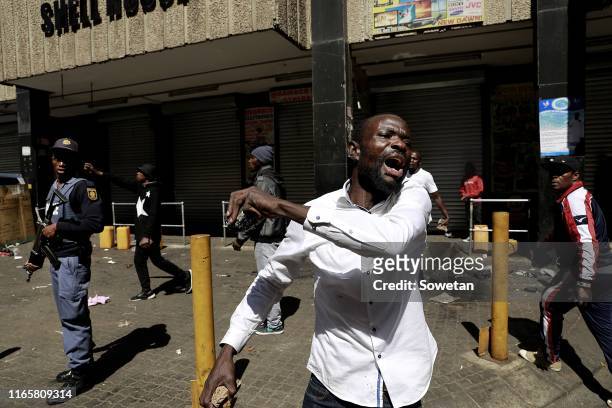 Foreign national reacts after looting and violence erupted on September 02, 2019 in Johannesburg, South Africa. Shops in and around various parts of...