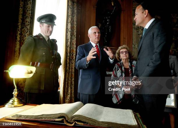 Vice President Mike Pence, Mrs Nancy Pence-Fritsch and Leo Varadkar, An Taoiseach are shown the service records of Pence's grandfather, Richard...