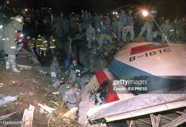 Rescue workers search for victims in the debris of a China Airlines Airbus A-300 which crashed 26 April 1994 shortly before landing at Nagoya's...