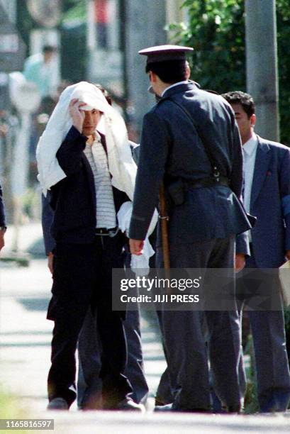 This 05 October 1989 file picture shows Tsutomu Miyazaki at an inspection of a murder case as he was convicted of killing four young girls and eating...