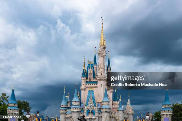 The Cinderella Castle during an overcast day is seen in the Walt Disney's Magic Kingdom theme park. The park is a famous place and tourist attraction.