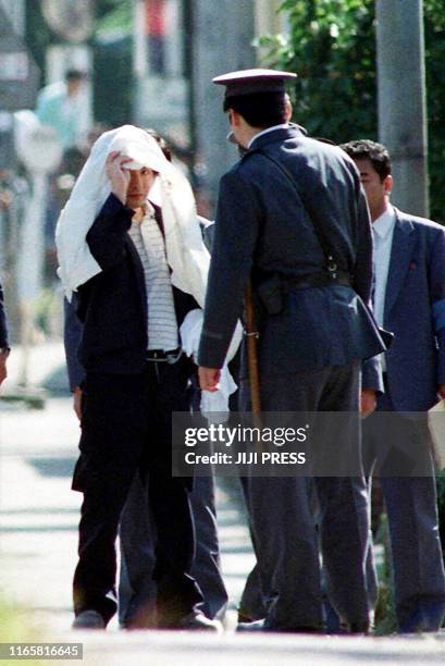 This 05 October 1989 file picture shows Tsutomu Miyazaki at an inspection of a murder case as he was convicted of killing four young girls and eating...