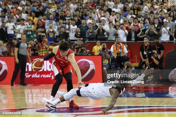 Cedi Osman of Turkey drives against Marcus Smart of USA during the 1st round Group E match between USA and Turkey of 2019 FIBA World Cup at the...