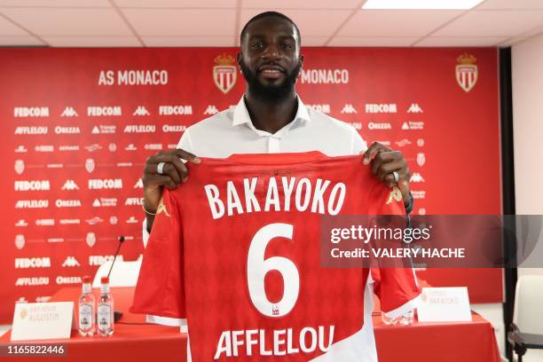 Monaco's French midfielder Tiemoue Bakayoko poses with his jersey after a press conference held for his presentation in La Turbie, near Monaco on...