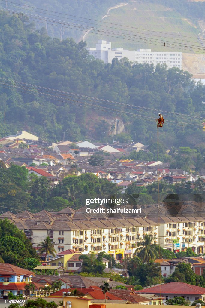 Workers working on power lines at sub urban area of Kuala Lumpur, Malaysia.