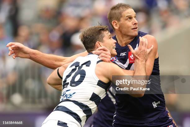 Tom Hawkins of the Cats and Aaron Sandilands of the Dockers contest the ruck during the round 20 AFL match between the Fremantle Dockers and the...