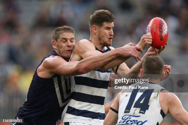 Aaron Sandilands of the Dockers tackles Zac Smith of the Cats during the round 20 AFL match between the Fremantle Dockers and the Geelong Cats at...